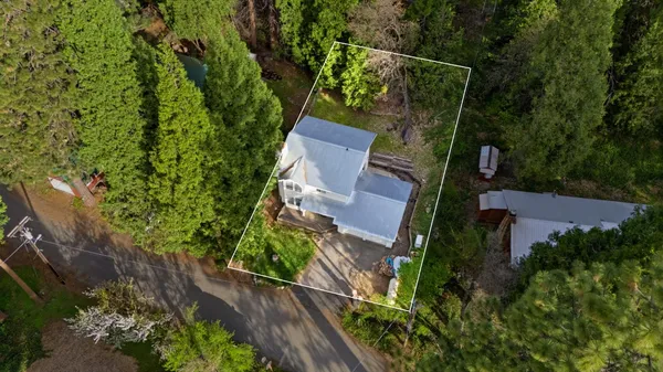 an aerial view of a house with a yard basket ball court and outdoor seating