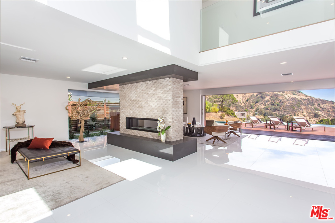 7524 Devista Drive Los Angeles, CA 90046 - Photo 4 of 54 a living room with furniture potted plant and a large window