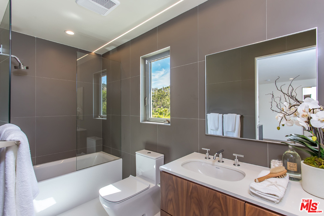 7524 Devista Drive Los Angeles, CA 90046 - Photo 36 of 54 a bathroom with a sink toilet tub and shower