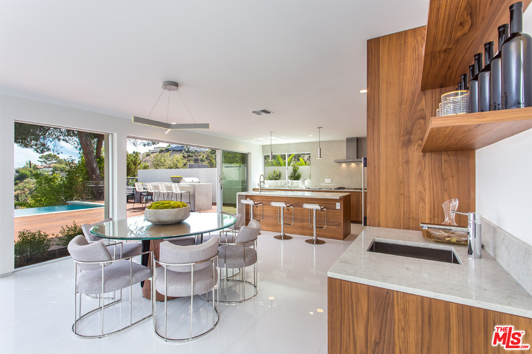 7524 Devista Drive Los Angeles, CA 90046 - Photo 8 of 54 a kitchen with a dining table chairs and large window
