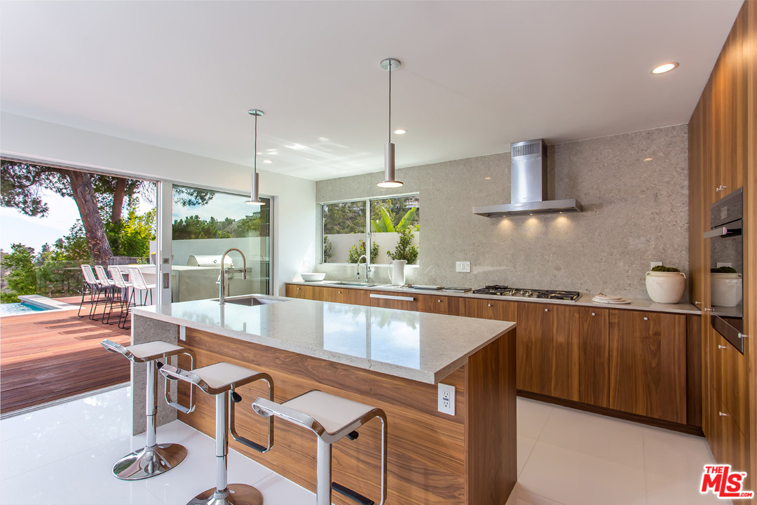 7524 Devista Drive Los Angeles, CA 90046 - Photo 9 of 54 a kitchen with stainless steel appliances granite countertop a sink a stove and a wooden floors