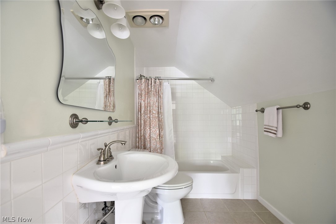23901 Hazelmere Road Shaker Heights, OH 44122 - Photo 32 of 35 Bathroom featuring tile walls, shower / tub combo, toilet, and tile flooring