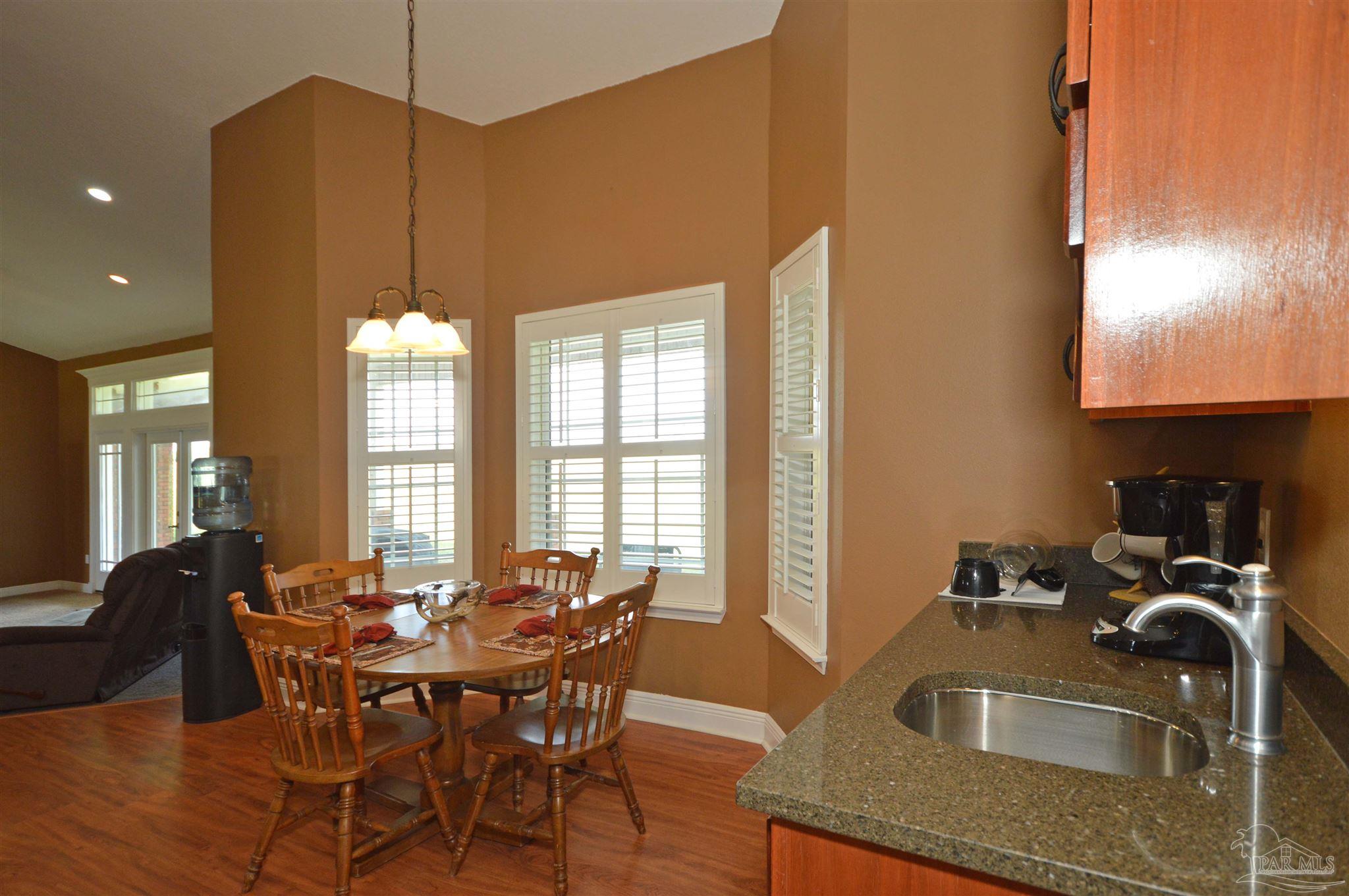 3478 Pine Level Church Road Jay, FL 32565 - Photo 22 of 50 a kitchen with granite countertop a sink a counter top space and living room view