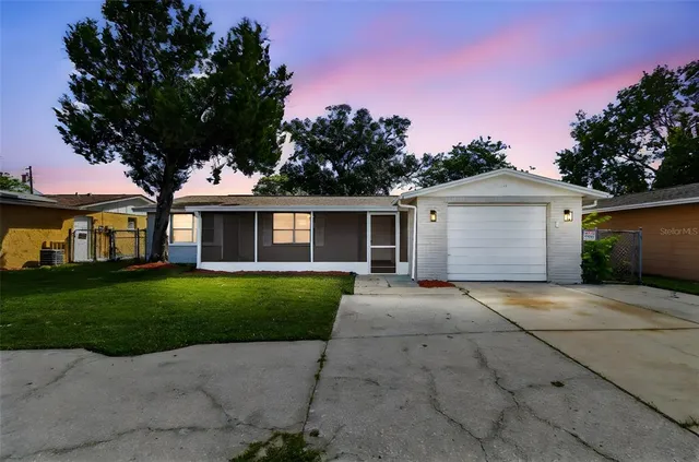 a front view of a house with a garden and yard