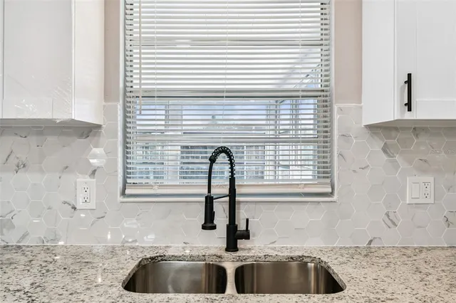 an empty room with a window and a mirror