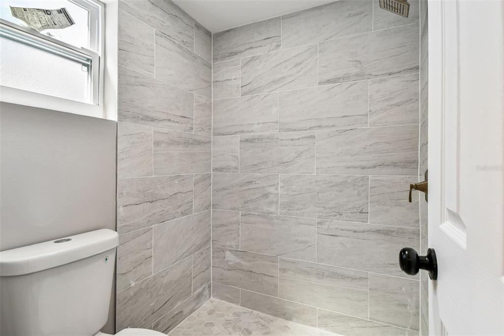 3800 Darlington Road Holiday, FL 34691 - Photo 12 of 36 a bathroom with a shower