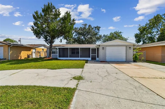 a living room with furniture kitchen view and a flat screen tv
