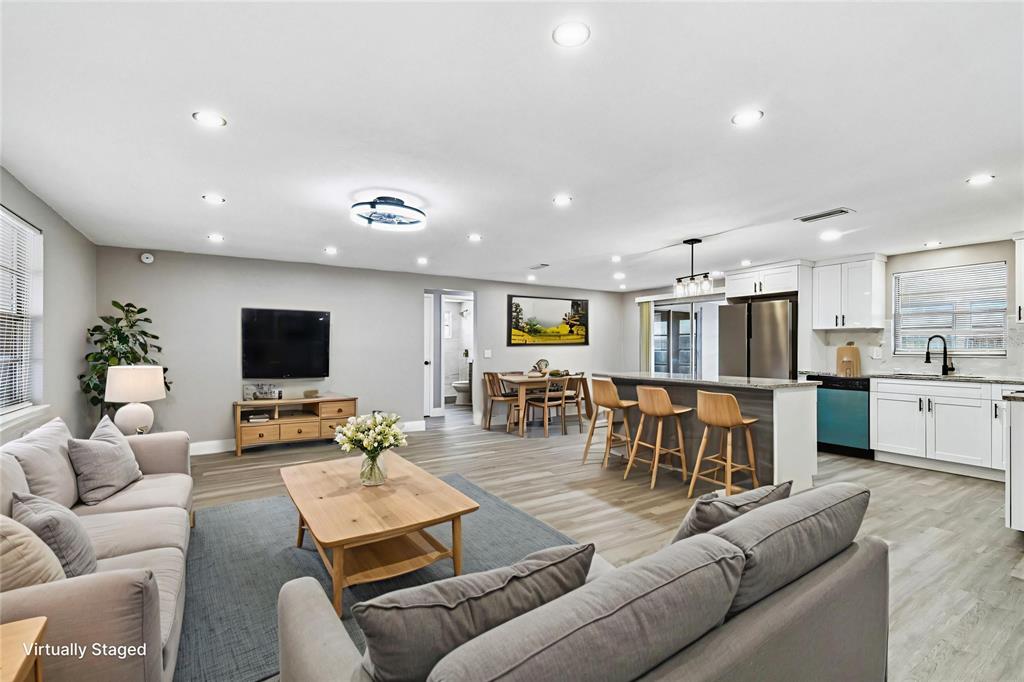 3800 Darlington Road Holiday, FL 34691 - Photo 3 of 36 a living room with furniture kitchen view and a flat screen tv