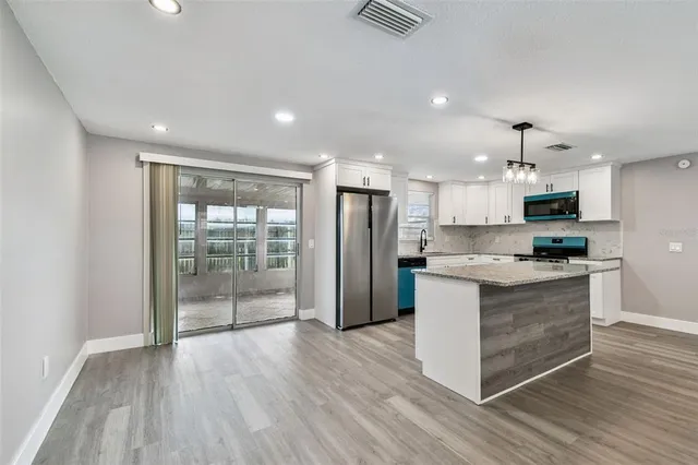 a bedroom with a bed and a potted plant