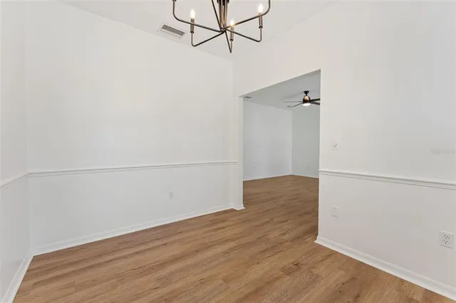 a kitchen with white cabinets and sink
