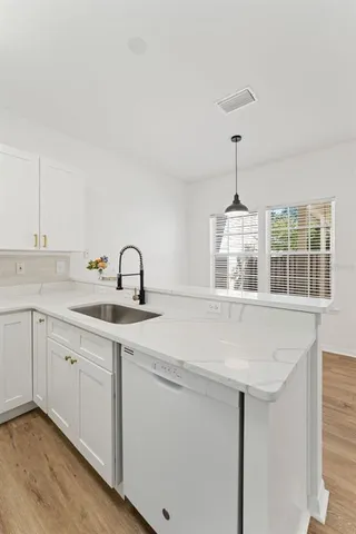 a view of a hallway with wooden floor and closet