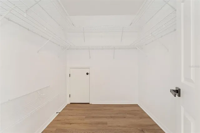 a bathroom with a toilet sink vanity and mirror