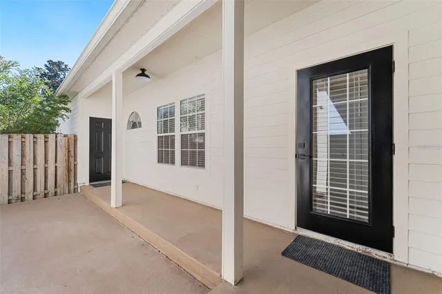 a yellow house with trees in front of it