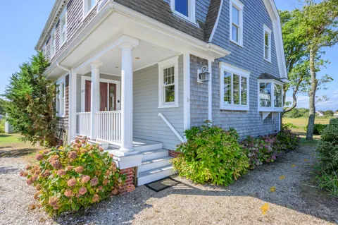 a view of a house with potted plants