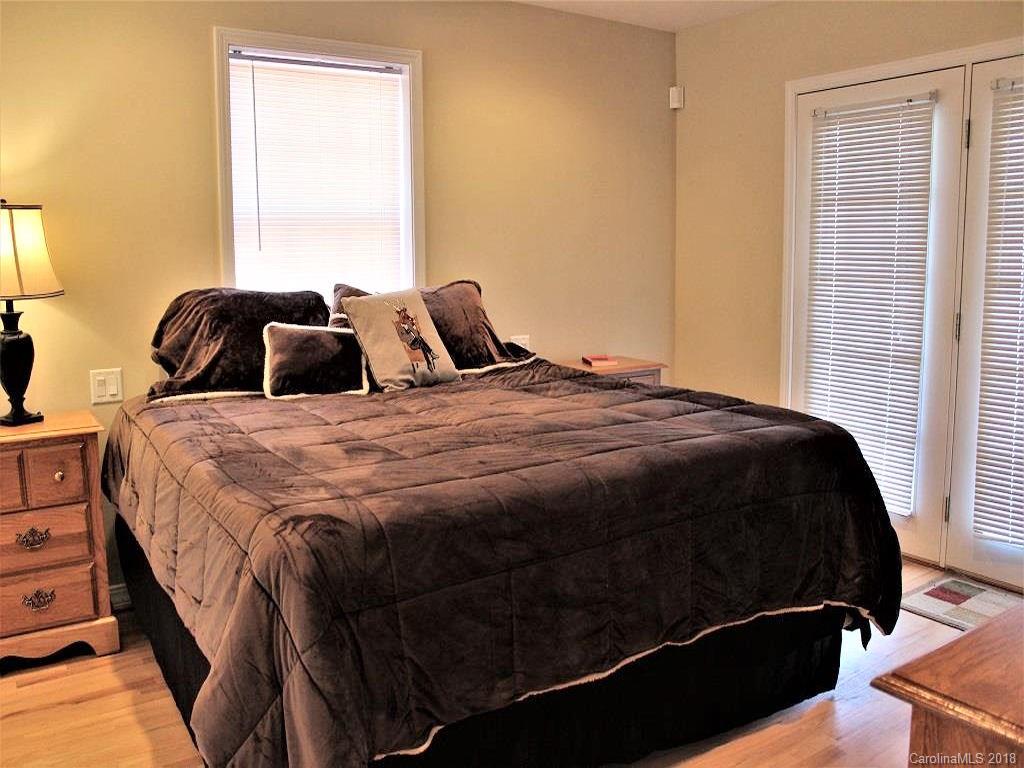 624 Carpenter Road Bryson City, NC 28713 - Photo 12 of 33 a bedroom with a bed lamp and a window