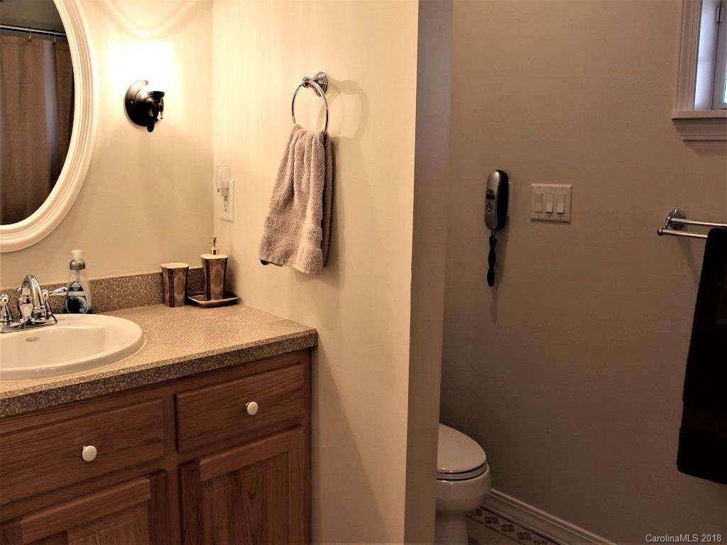 624 Carpenter Road Bryson City, NC 28713 - Photo 17 of 33 a bathroom with a granite countertop sink toilet and a mirror