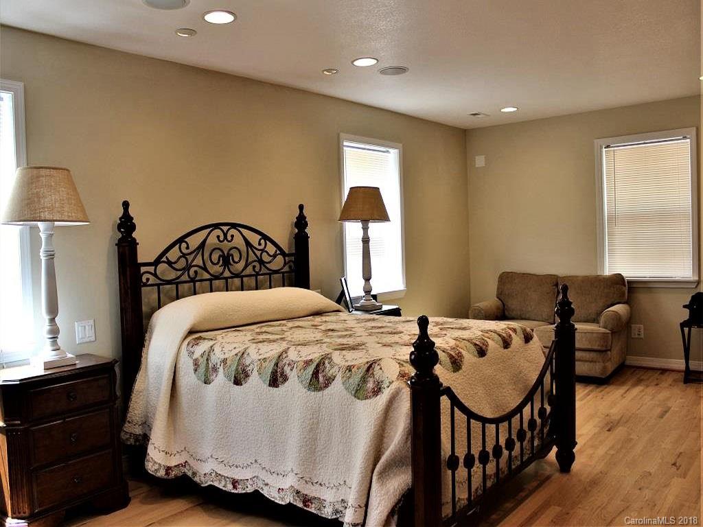 624 Carpenter Road Bryson City, NC 28713 - Photo 20 of 33 a bedroom with a bed and wooden floor