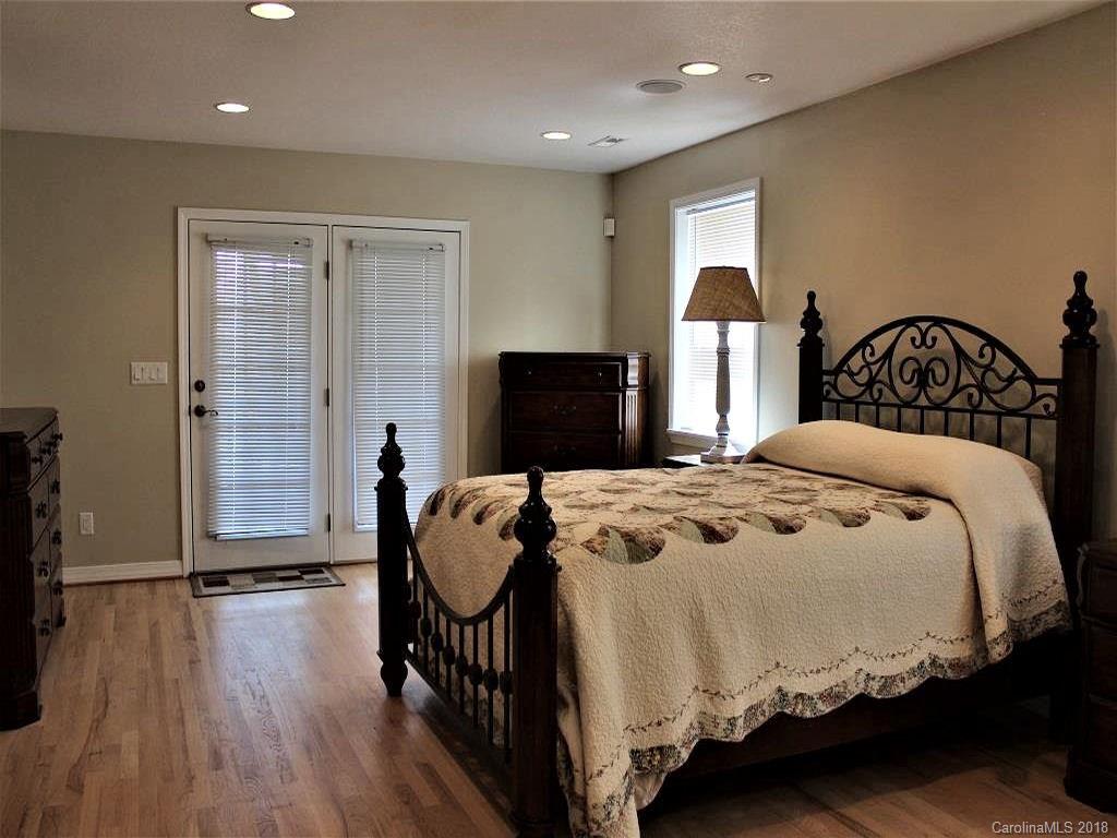 624 Carpenter Road Bryson City, NC 28713 - Photo 21 of 33 a bedroom with a bed and wooden floor