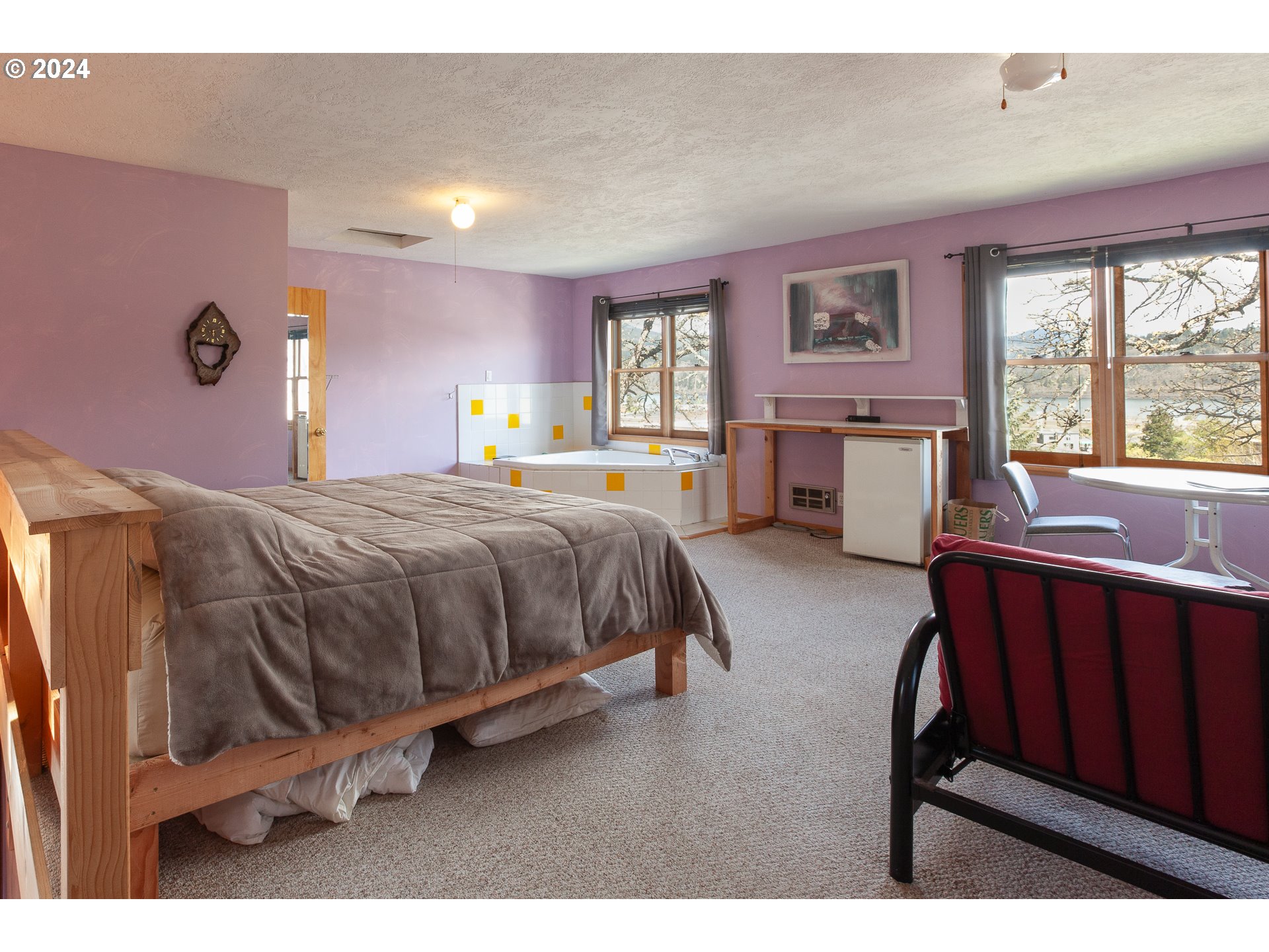 1 State Street Hood River, OR 97031 - Photo 15 of 47 a bedroom with a bed window with table and chair