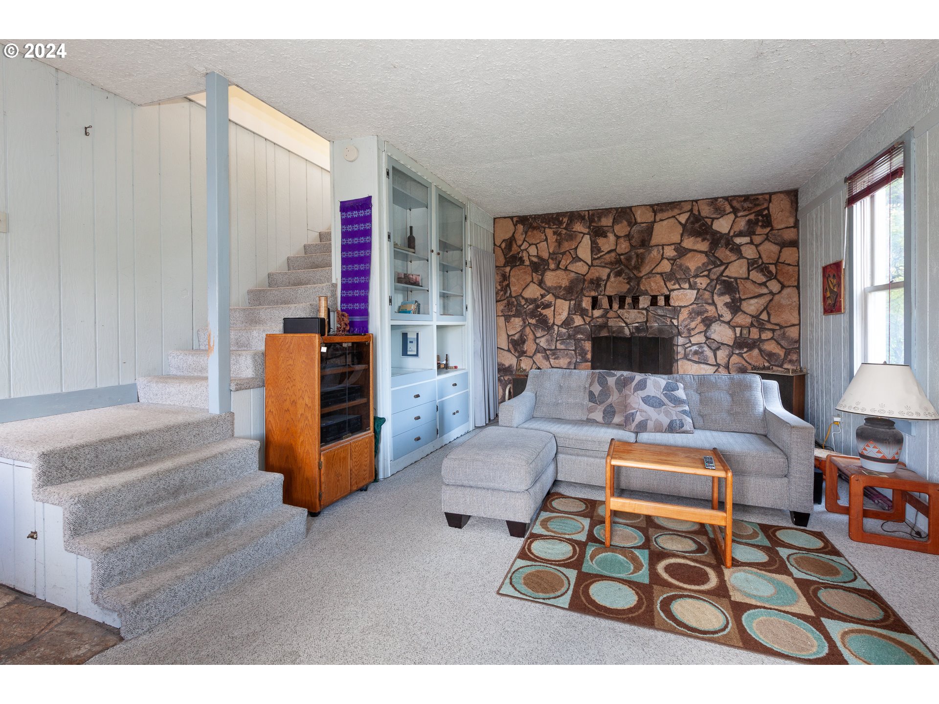 1 State Street Hood River, OR 97031 - Photo 35 of 47 a living room with furniture and a large window