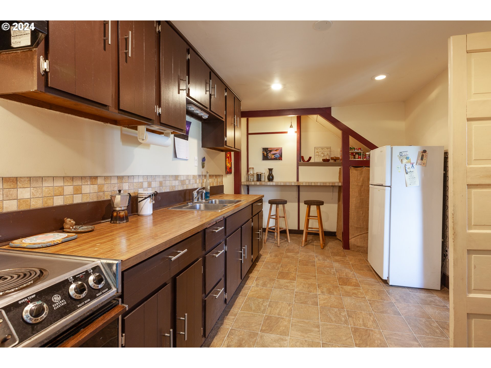 1 State Street Hood River, OR 97031 - Photo 42 of 47 a kitchen with stainless steel appliances granite countertop a sink a stove and a refrigerator