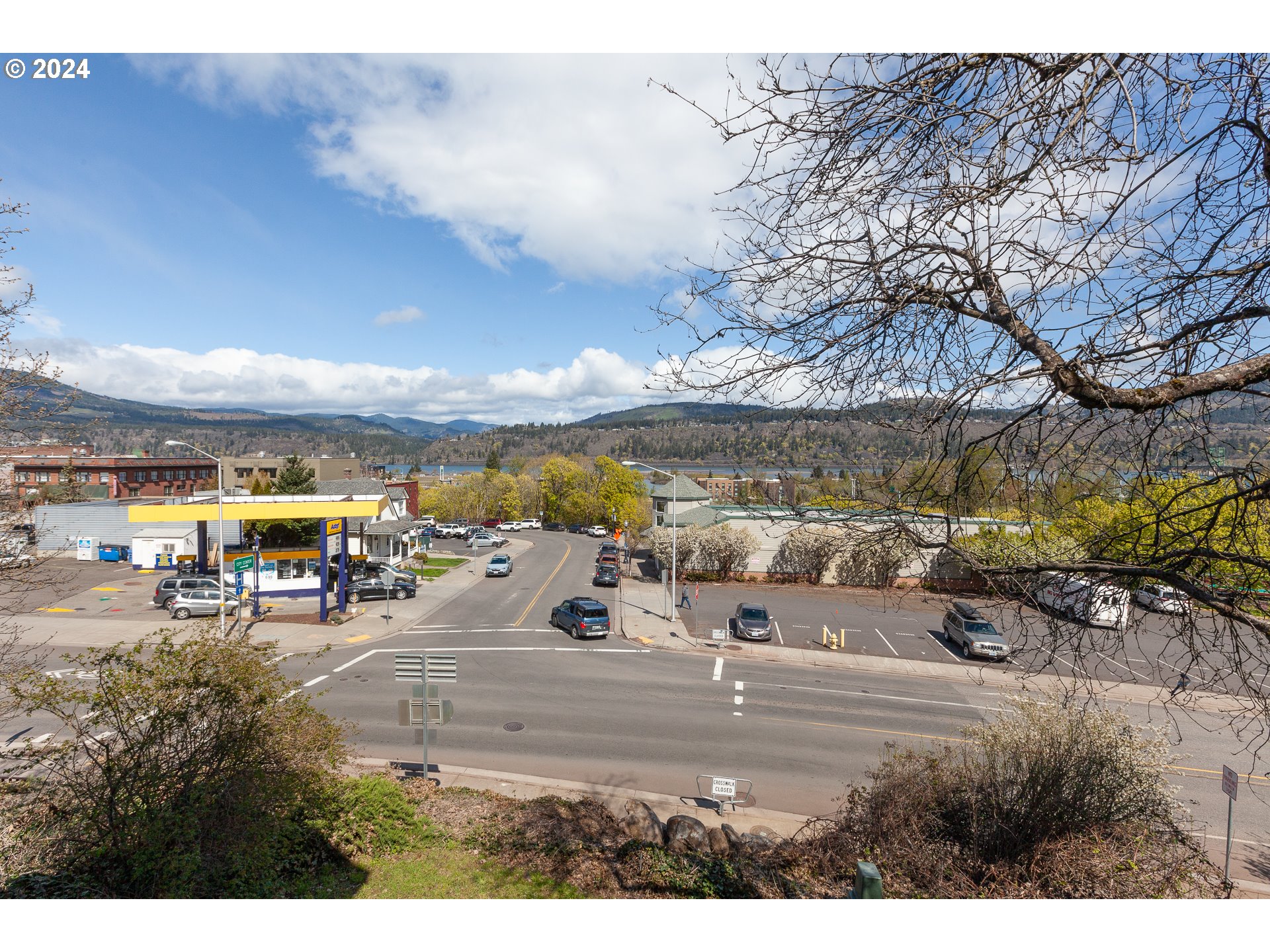 1 State Street Hood River, OR 97031 - Photo 46 of 47 a view of a lake with a table and chairs under an umbrella