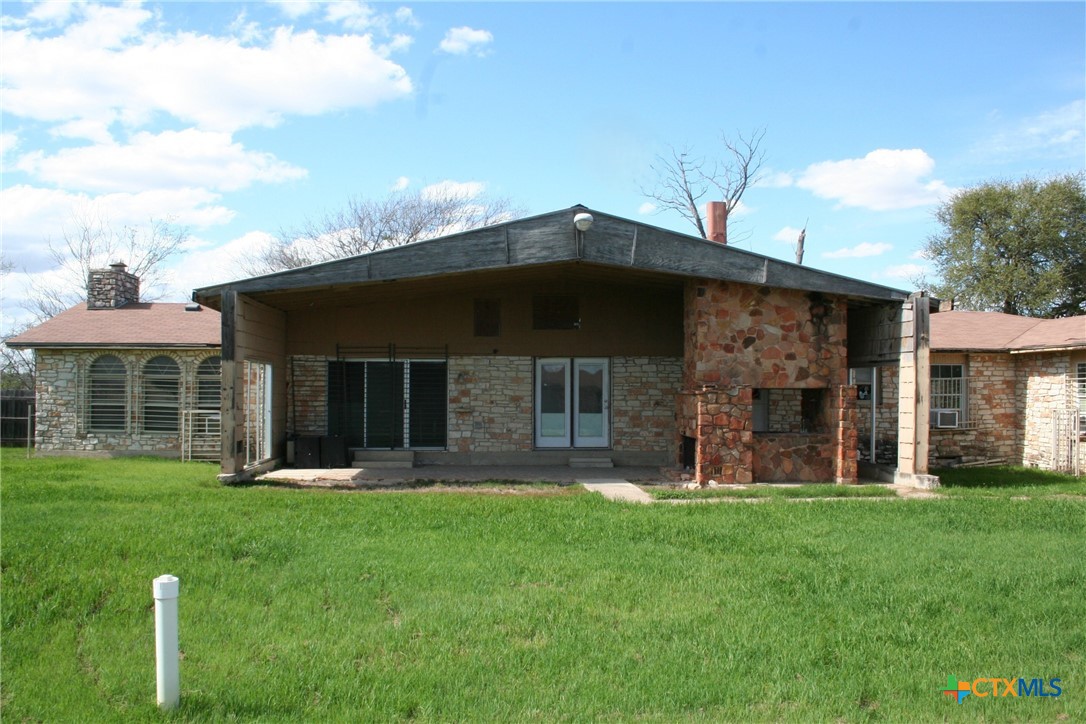 a view of a house with a yard and sitting area