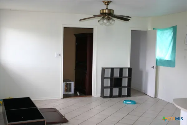 a view of a room with wooden floor and windows