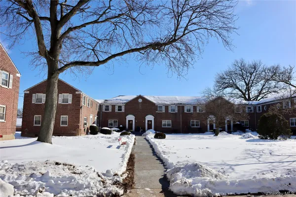 a view of a house with a yard covered in snow