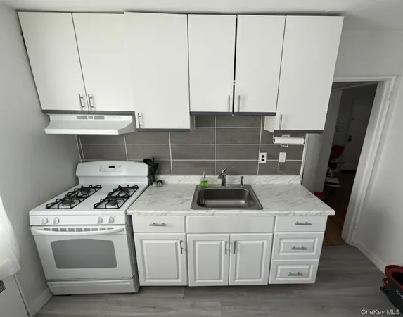 a kitchen with white cabinets and white appliances