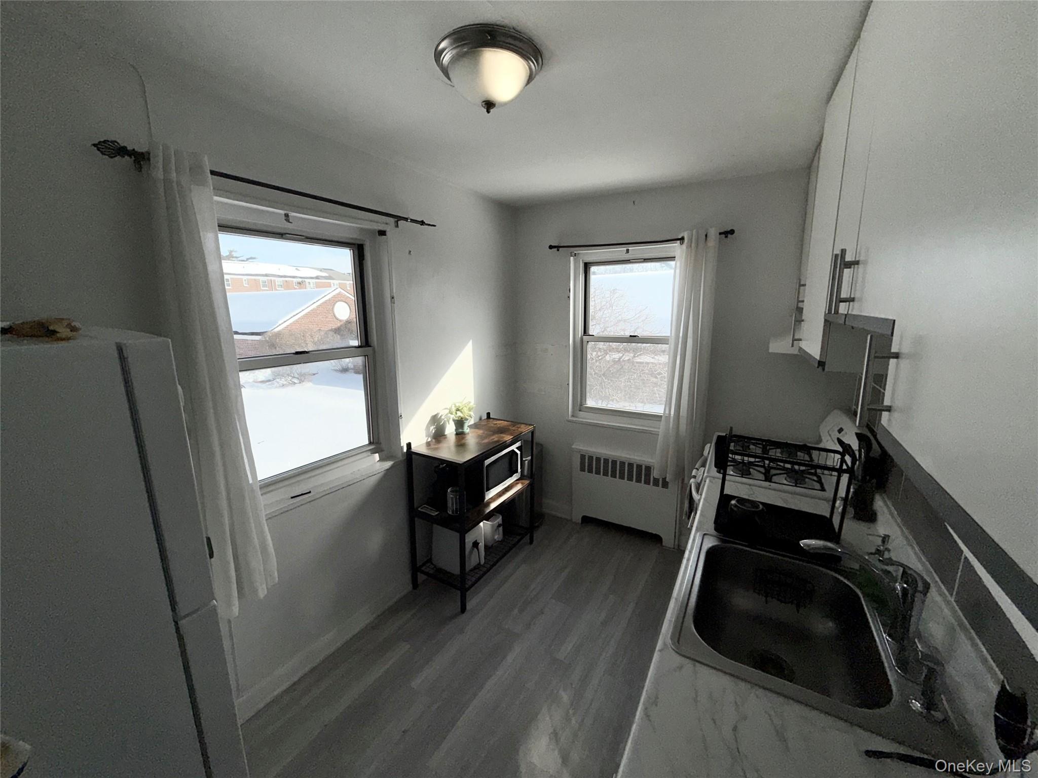 131-39 234th Street, Unit LL Queens, NY 11422 - Photo 8 of 10 a room with furniture and a window