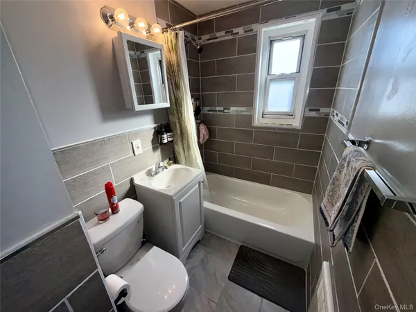 a bathroom with a toilet a sink and bathtub