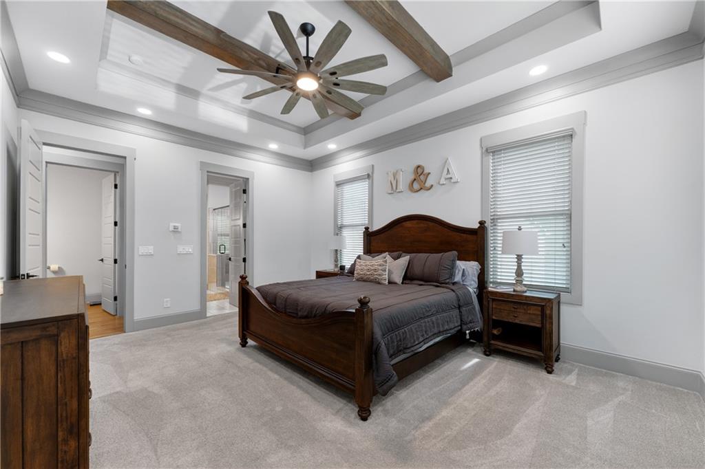 4726 Crestview Way Flowery Branch, GA 30542 - Photo 21 of 48 a spacious bedroom with a bed and a chandelier