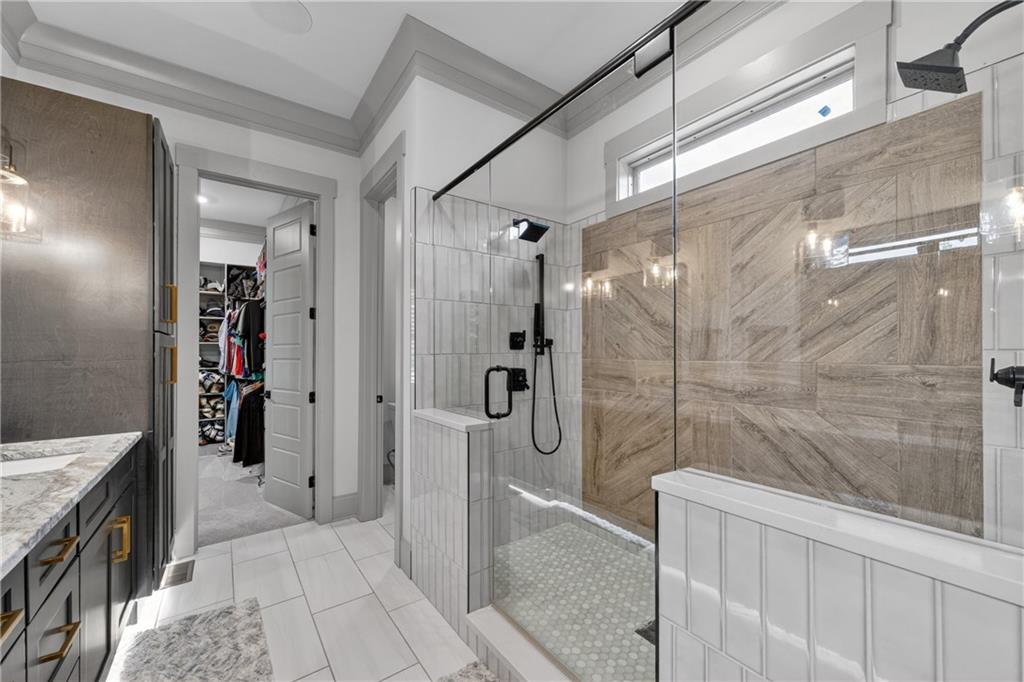4726 Crestview Way Flowery Branch, GA 30542 - Photo 22 of 48 a bathroom with a shower and a mirror