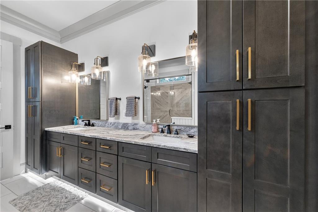 4726 Crestview Way Flowery Branch, GA 30542 - Photo 23 of 48 a bathroom with a double vanity sink and mirror