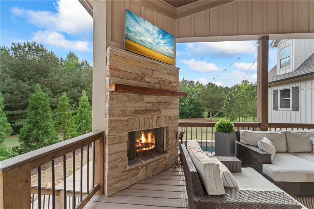 4726 Crestview Way Flowery Branch, GA 30542 - Photo 24 of 48 a view of a balcony with furniture and a floor to ceiling window