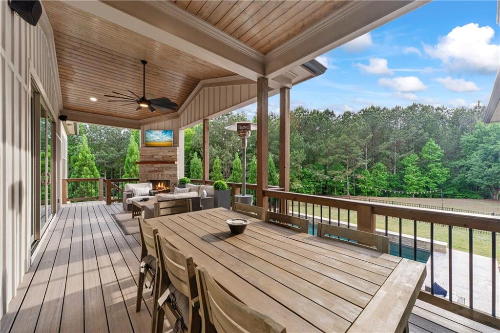 4726 Crestview Way Flowery Branch, GA 30542 - Photo 25 of 48 a view of a patio with a table chairs and a backyard