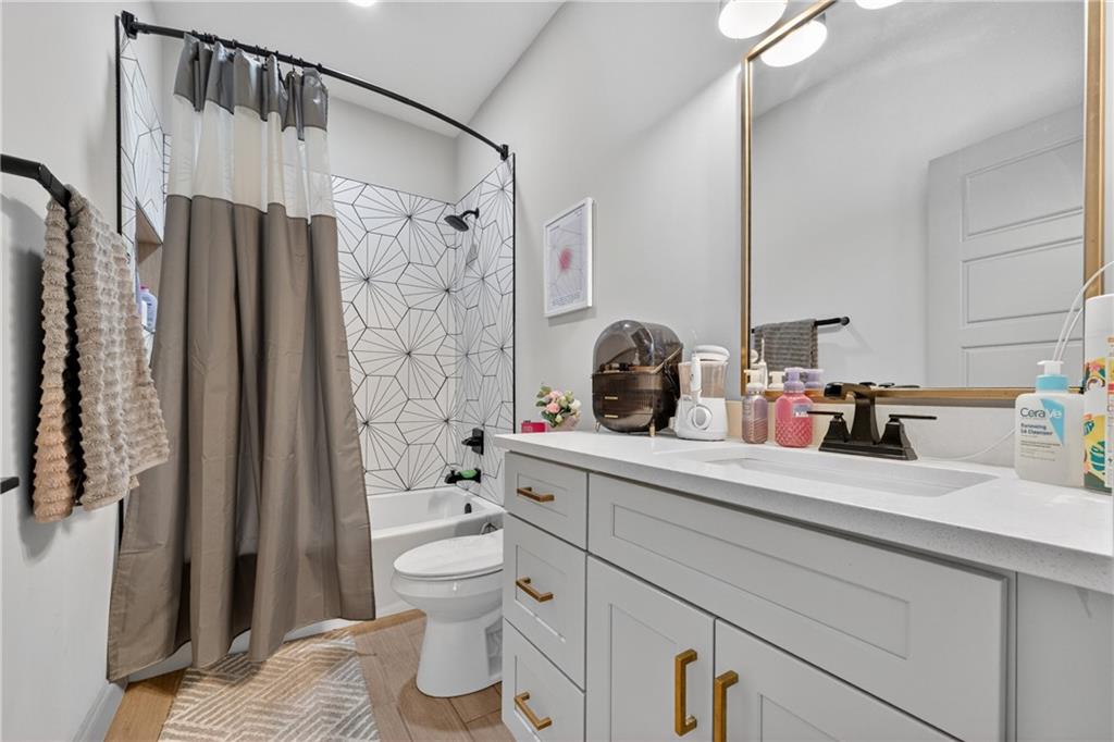4726 Crestview Way Flowery Branch, GA 30542 - Photo 27 of 48 a bathroom with a sink a toilet and shower
