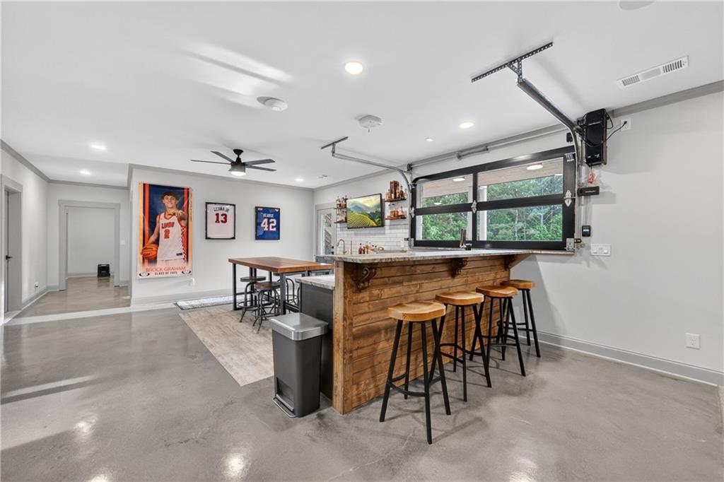 4726 Crestview Way Flowery Branch, GA 30542 - Photo 35 of 48 a dining hall with stainless steel appliances a dining table and chairs with kitchen island