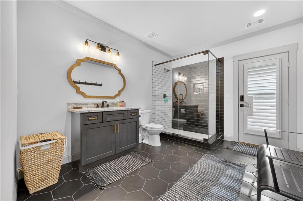 4726 Crestview Way Flowery Branch, GA 30542 - Photo 37 of 48 a bathroom with a toilet a sink and mirror