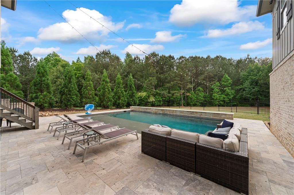 4726 Crestview Way Flowery Branch, GA 30542 - Photo 41 of 48 a view of swimming pool with chairs and wooden fence