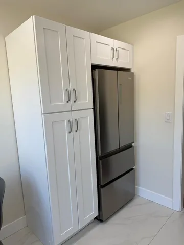 a view of a refrigerator in kitchen