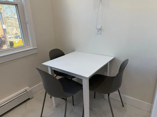 a view of a dining room with furniture and window