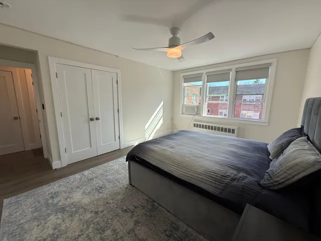 a bed sitting in a bedroom next to a window