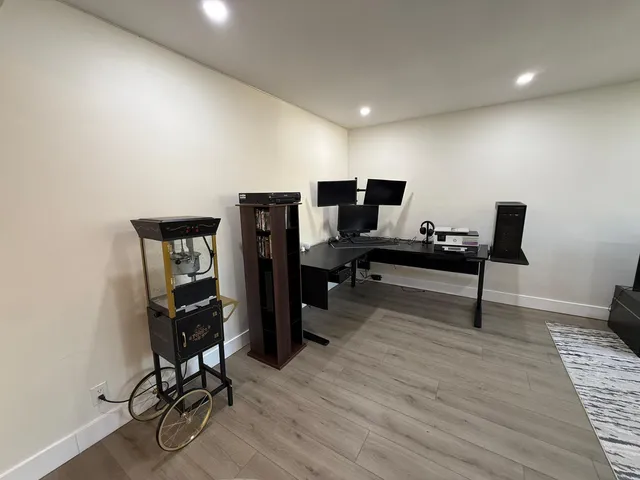 a view of a workspace with furniture and a workspace