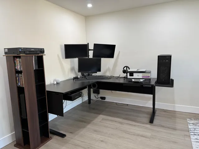 a view of a workspace with furniture and wooden floor