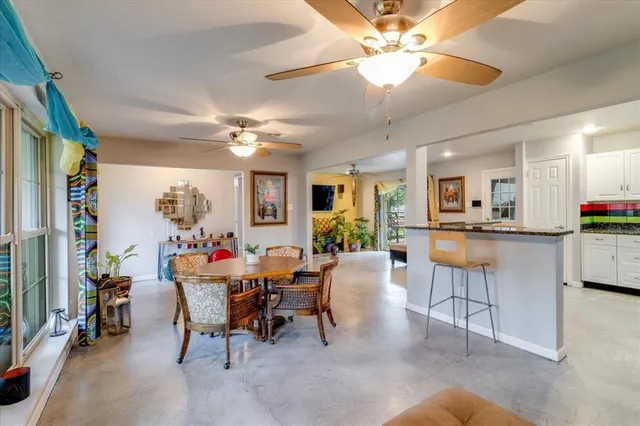 a view of a dining room with furniture and a chandelier
