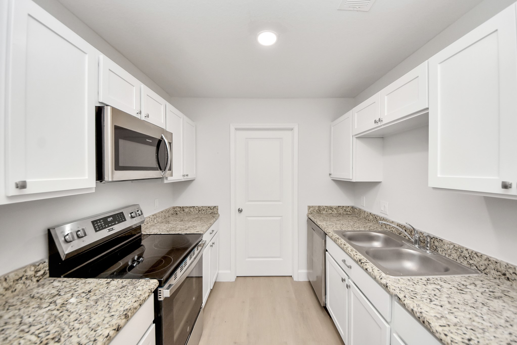 16124 Brettwood Lane Splendora, TX 77372 - Photo 11 of 40 a kitchen with a stove and a microwave