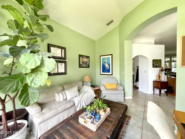 a living room with furniture and a potted plant
