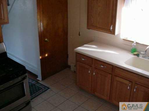 441 Front Street Dunellen, NJ 08812 - Photo 7 of 8 a kitchen with a sink and cabinets